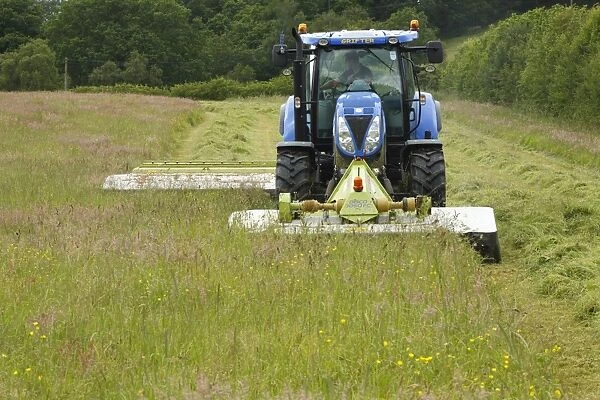 Contractor with New Holland T6080 tractor with front and rear mounted Cls mowers
