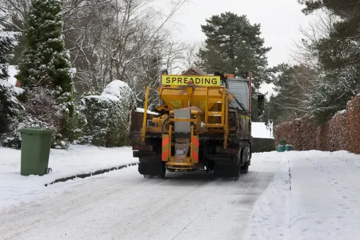 Framed Print : Council gritter lorry gritting snow covered residential road, Surrey, England, January