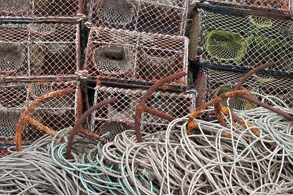 Crab fishing pots, rusty anchors and ropes, Cley Beach, Cley-next-the-sea, Norfolk, England, October