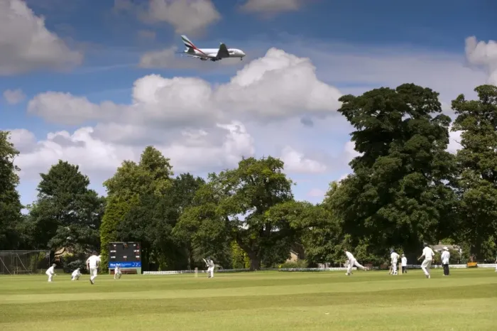 Framed Print : Cricket match being played on village pitch, on summer afternoon, underneath flight path to Manchester International Framed Print : Cricket match being played on village pitch, on summer afternoon, underneath flight path to Manchester International