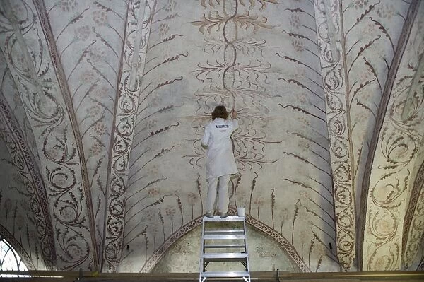 Curator repairing painting on church ceiling, Tierp, Uppsala County, Uppland, Sweden, march