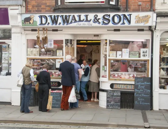 Framed Print : Customers queueing outside traditional butcher's shop, Ludlow, Shropshire, England, september