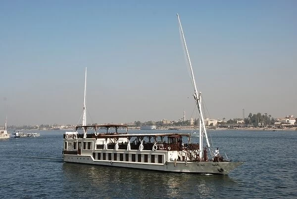 Dahabiya passenger boat cruising on river, River Nile, Luxor, Egypt, january