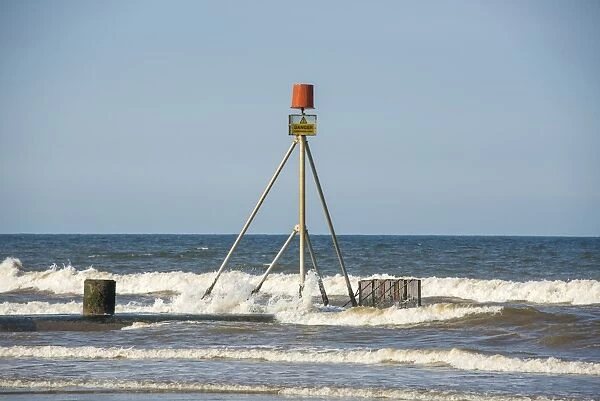 Danger, Hazardous Area sign on drainage outfall into sea, Anderby Creek, Lincolnshire, England, June