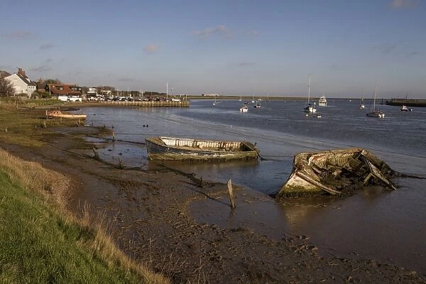 Decaying old boats on mud in The River Alde by Orford, Suffolk