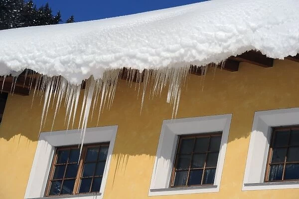 Deep snow and icicles on roof, Davos, Graubunden, Swiss Alps, Switzerland, january