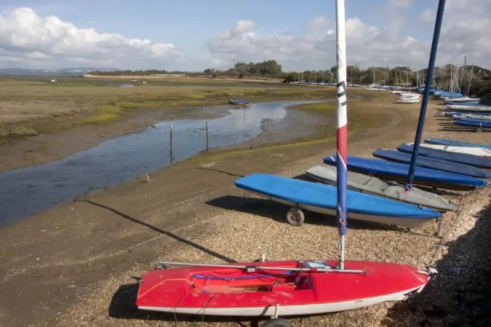 Framed Print : Dinghies moored beside coastal creek at low tide, Roman Landing, East Head Creek, West Wittering, Manhood Peninsula