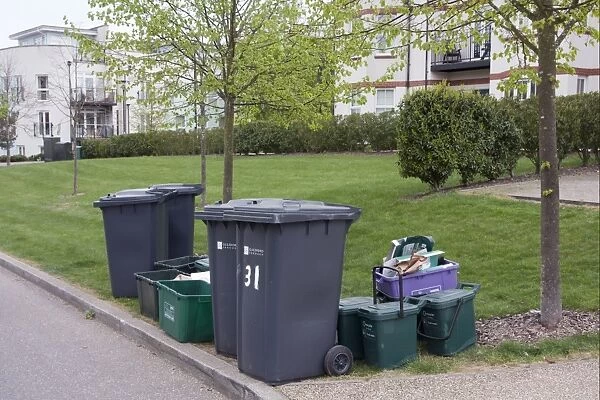 Domestic refuse and recycling, waiting for collection on housing estate, Guildford, Surrey, England, april