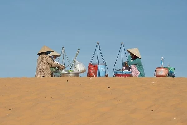 Drink sellers in conical hats, sitting on coastal sand dunes, Phan Thiet, Binh Thuan Province, Vietnam, December