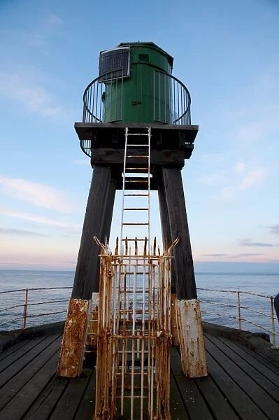 Early 20th century wooden lighhouse at end of pier, West Pier, Whitby, North Yorkshire, England, March