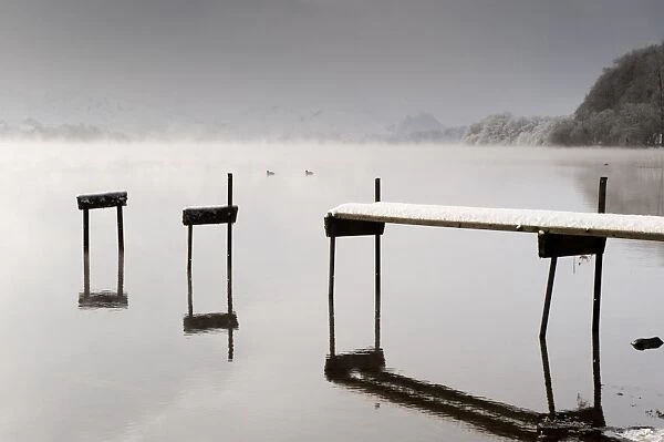 Early morning mist on upland lake, Ullswater, Lake District, Cumbria, England, december