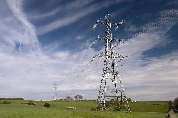 Electricity transmission pylons crossing farmland, Lancashire, England, April