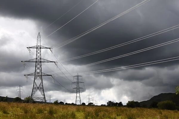 Electricity transmission pylons and stormclouds, above Conwy Valley, Carneddau Mountain Range, Snowdonia N. P
