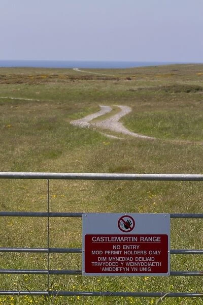 No Entry, MOD Permit Holders Only bilingual sign on gate at coastal military firing range, Castlemartin Range
