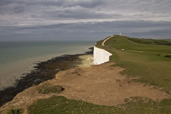 Erosion on chalk downland sea cliffs at Beachy Head looking towards Belle Tout lighthouse