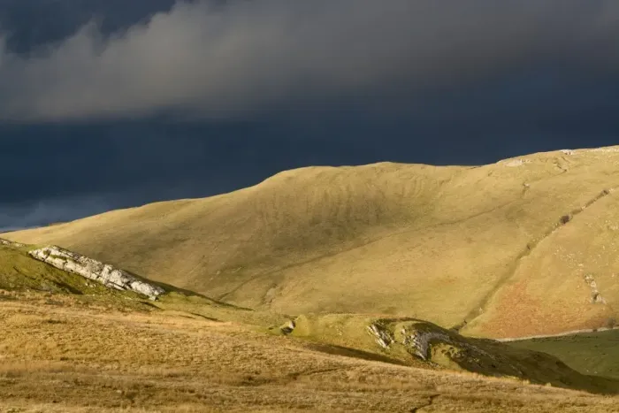 Framed Print : Evening sunlight on fells with stormclouds behind, near Kirkby Stephen, Cumbria, England, March Framed Print : Evening sunlight on fells with stormclouds behind, near Kirkby Stephen, Cumbria, England, March