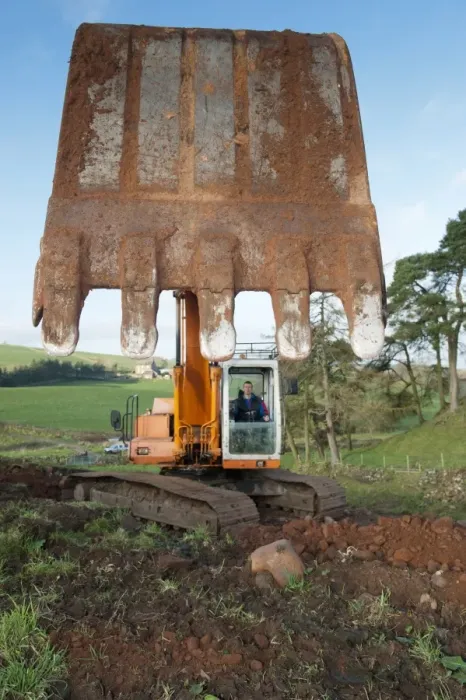 Framed Print : Excavator digging stone on hillside, England, november