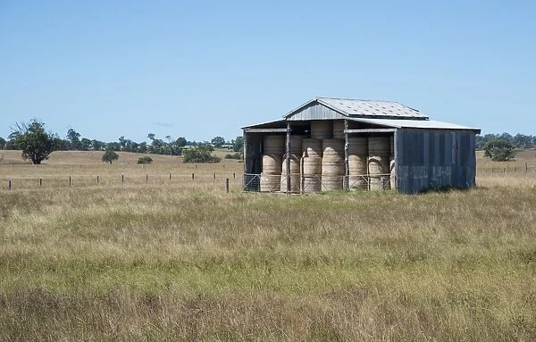 Farm building with round hay bales, Lakes Entrance, Victoria, Australia, February