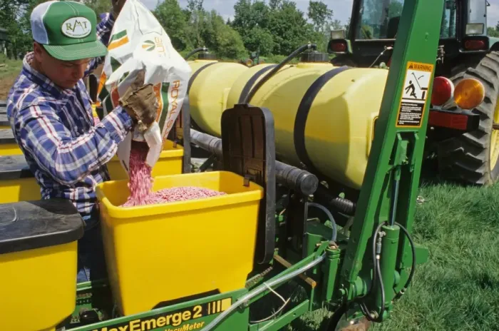 Framed Print : Farmer loading green bean seeds into seed drill hopper, St. Paul, Oregon, U. S. A Framed Print : Farmer loading green bean seeds into seed drill hopper, St. Paul, Oregon, U. S. A