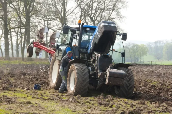 Framed Print : Farmer repairing New Holland tractor with plough in field, Lochmaben, Lockerbie, Dumfries and Galloway, Scotland, april Framed Print : Farmer repairing New Holland tractor with plough in field, Lochmaben, Lockerbie, Dumfries and Galloway, Scotland, april