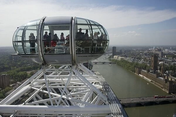 Ferris wheel passenger capsules overlooking city river, London Eye, South Bank, River Thames, Lambeth, London, England