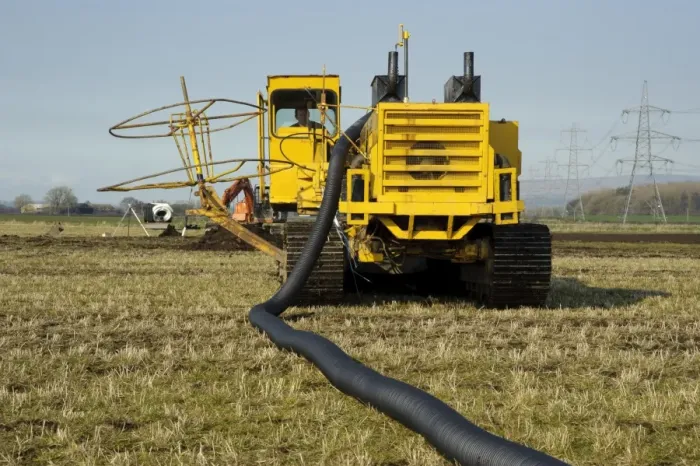 Framed Print : Field drainage, continuous pipe laying machine working in arable field, Pilling, Lancashire, England, march Framed Print : Field drainage, continuous pipe laying machine working in arable field, Pilling, Lancashire, England, march