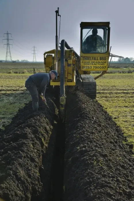 Framed Print : Field drainage, continuous pipe laying machine working in arable field, Pilling, Lancashire, England, march