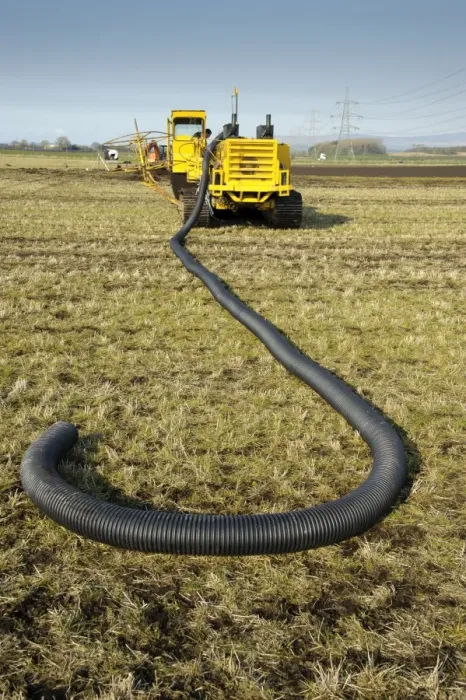 Framed Print : Field drainage, continuous pipe laying machine working in arable field, Pilling, Lancashire, England, march