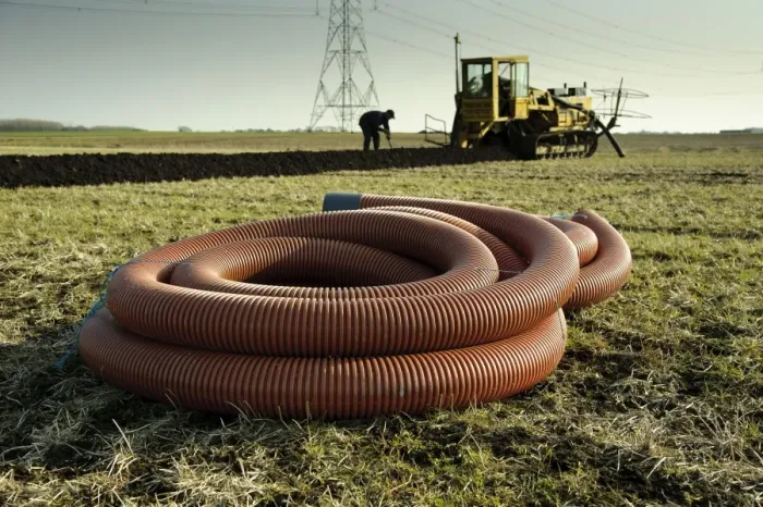 Framed Print : Field drainage, pipe and continuous pipe laying machine working in arable field, Pilling, Lancashire, England, march