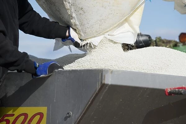 Filling Bredal TX3500 spreader with granular fertilizer, Tierp, Uppsala County, Uppland, Sweden, april