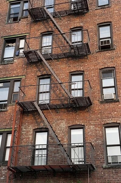 Fire escape ladders on side of brick apartment buildings, New York City, New York State, U. S. A. september