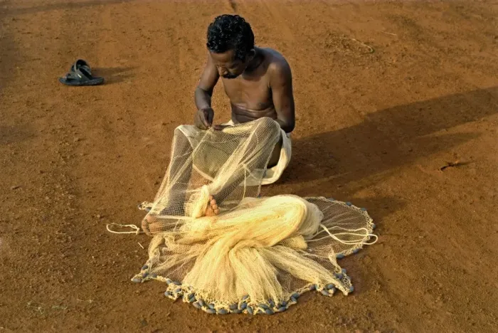 Framed Print : Fisherman mending nets on beach, Trivandrum, Kerala, India Framed Print : Fisherman mending nets on beach, Trivandrum, Kerala, India