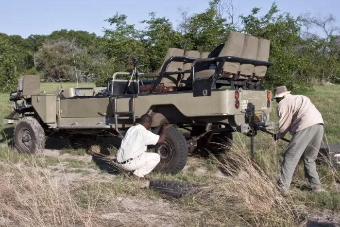Framed Print : Fixing a flat tyre in the African bush Uri 4 wheel drive
