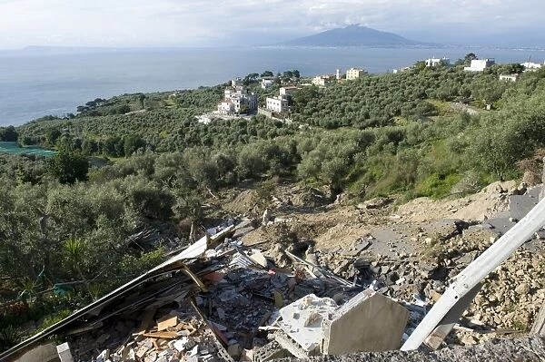 Flood damaged coastal road through olive groves and farmland, which has collapsed after heavy rain on the Bay of Naples