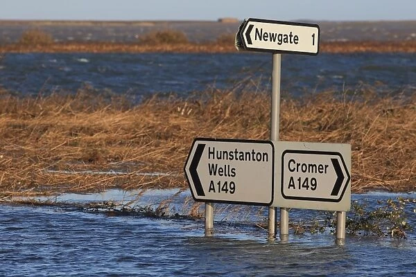 Flooded coast road and coastal marshland after tidal surge, Cley Marshes Reserve, Cley-next-the-sea, North Norfolk
