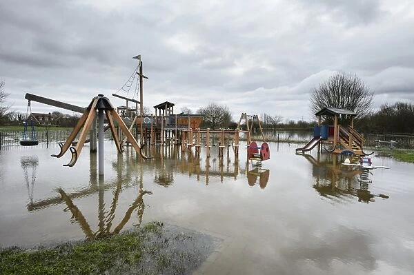 Floodwater in playground during river flood, River Thames, Chertsey, Surrey, England, February 2014