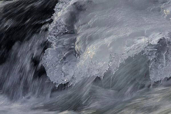 Flowing water and ice on partially frozen river, River Nith, Dumfries and Galloway, Scotland, december