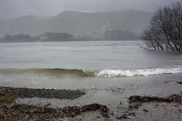 Heavy rain and stormy conditions on reservoir, with swollen streams running down side of Helvelyn, Thirlmere