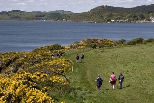 Hikers walking on coastal path, towards Rockcliffe and Kippford, Rough Firth, Solway Firth, Dumfries and Galloway