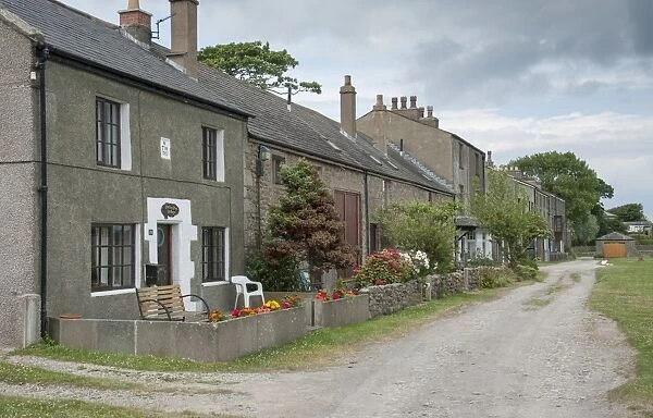 Houses in coastal village, only community on U. K. mainland dependent upon tidal access