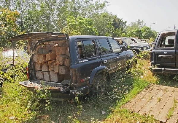 Illegal logging, impounded cars with illegally cut wood, Seima Protected Forest, Cambodia, January