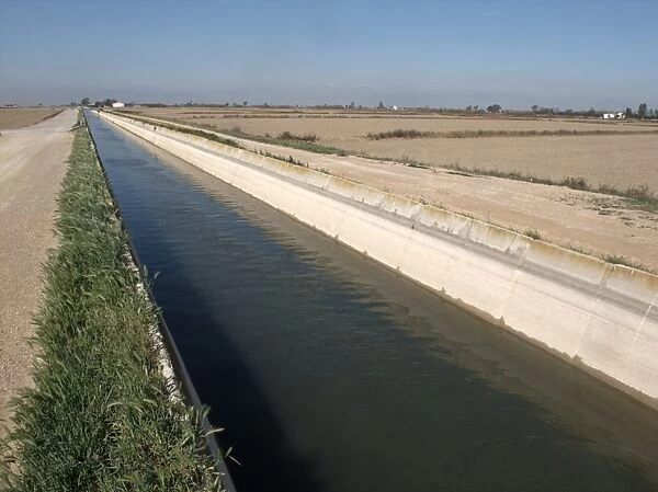 Irrigation canal carrying water to fields, Ebre Delta, Catalonia, Spain, april