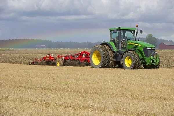 John Deere 7720 tractor with Vaderstad 560 flexible cultivator, cultivating stubble field, Sweden, august