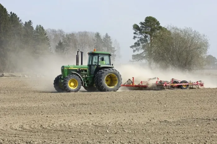 Framed Print : John Deere tractor pulling harrows, harrowing field with wind blown dust, Sweden, spring Framed Print : John Deere tractor pulling harrows, harrowing field with wind blown dust, Sweden, spring