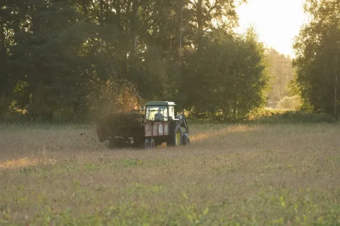 Framed Print : John Deere tractor pulling muck spreader, spreading muck on field in evening sunshine, Sweden Framed Print : John Deere tractor pulling muck spreader, spreading muck on field in evening sunshine, Sweden