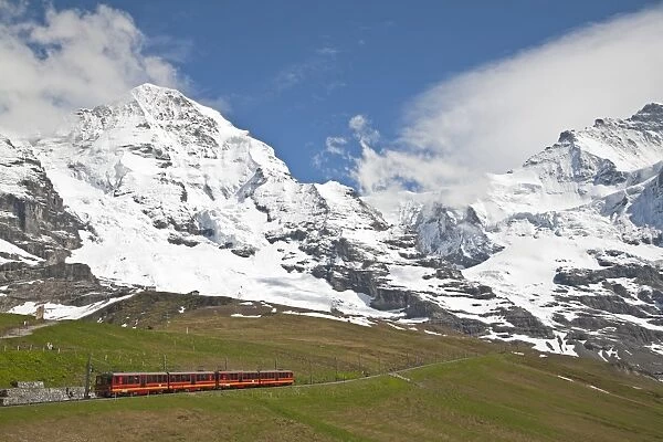 Jungfraubahn train leaving Kleine Scheidegg towards Jungfraujoch, Monch mountain in background, Bernese Alps