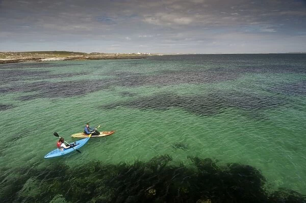 Two kayakers at sea, Hynish, Isle of Tiree, Inner Hebrides, Scotland, August