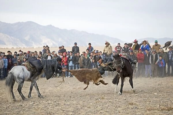 Kazakh riders in tug-of-war with goat skin during Kurbar game, Eagle Hunters Festival, Bayan-Ulgii, Western Mongolia