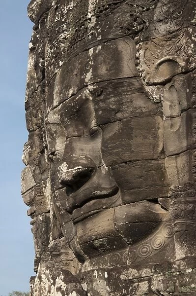 Large sculpture of head on tower of Khmer temple, Bayon, Angkor Thom, Siem Riep, Cambodia
