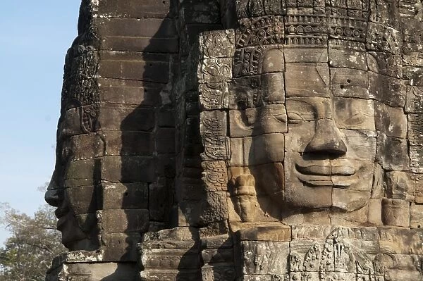 Large sculptures of heads on tower of Khmer temple, Bayon, Angkor Thom, Siem Riep, Cambodia